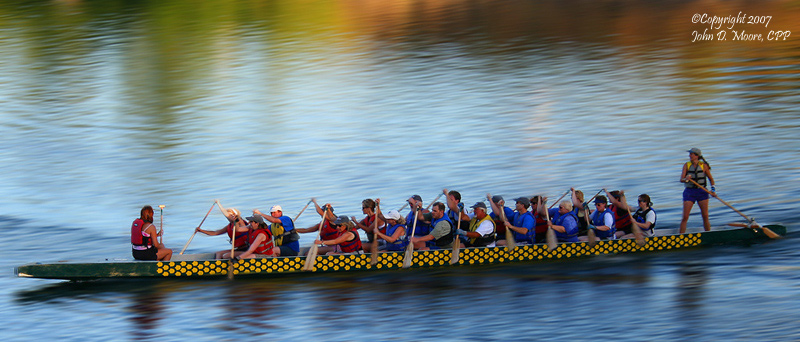 At sunset, a boat race on the Spokane River.